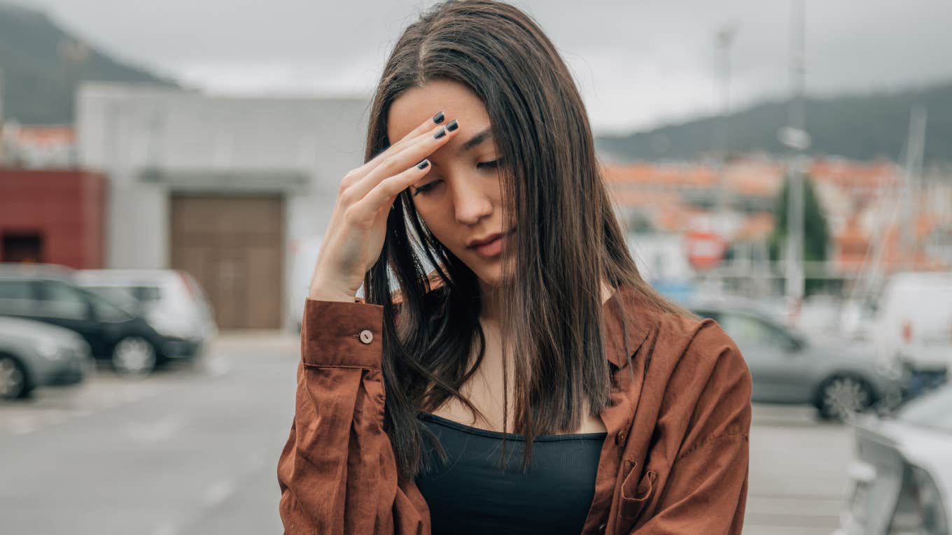 young woman covering face in shame embarrassed by appearance