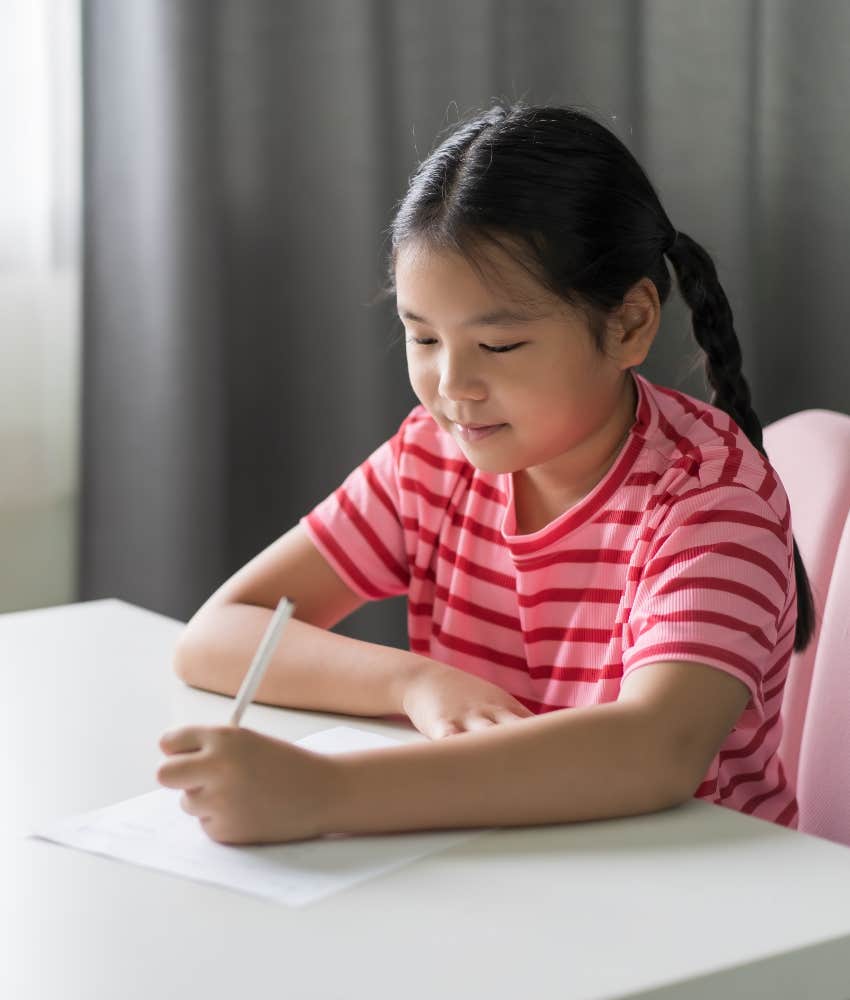 child doing worksheet for summer learning