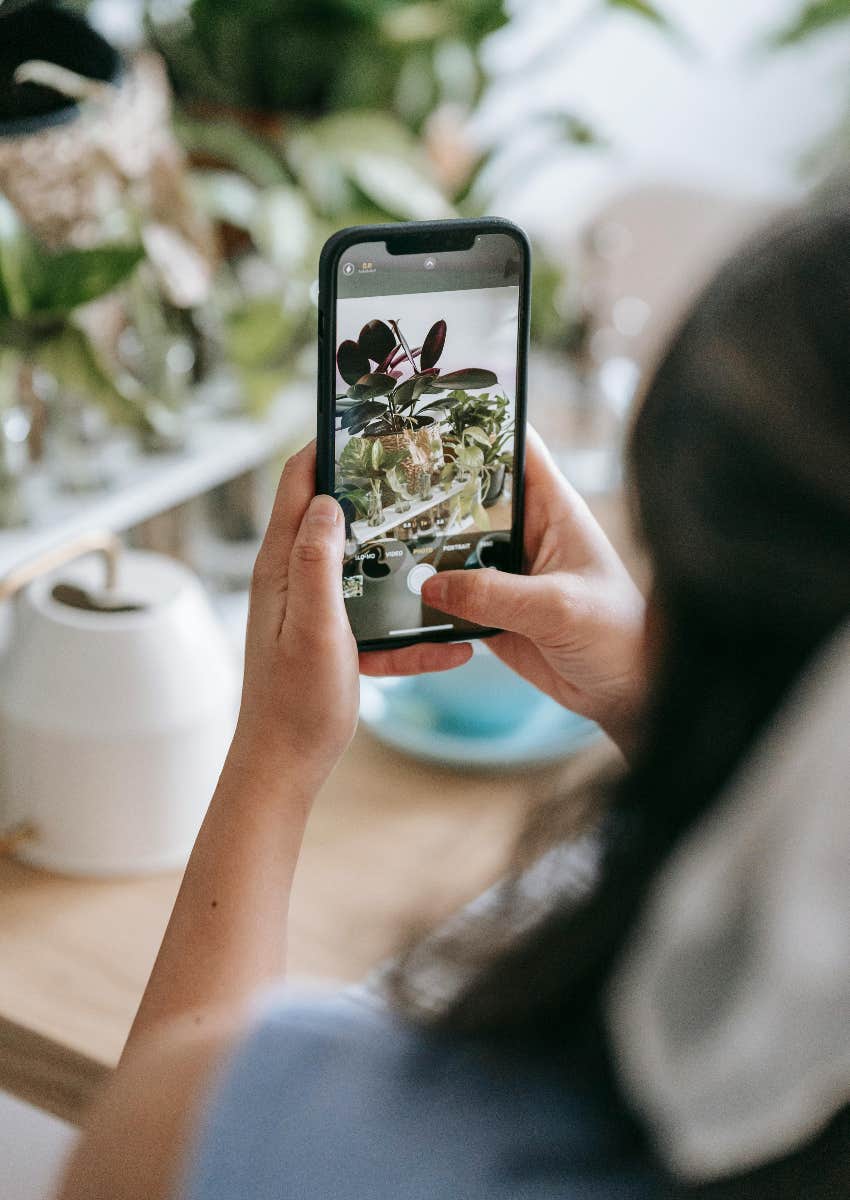 woman taking a picture with her phone