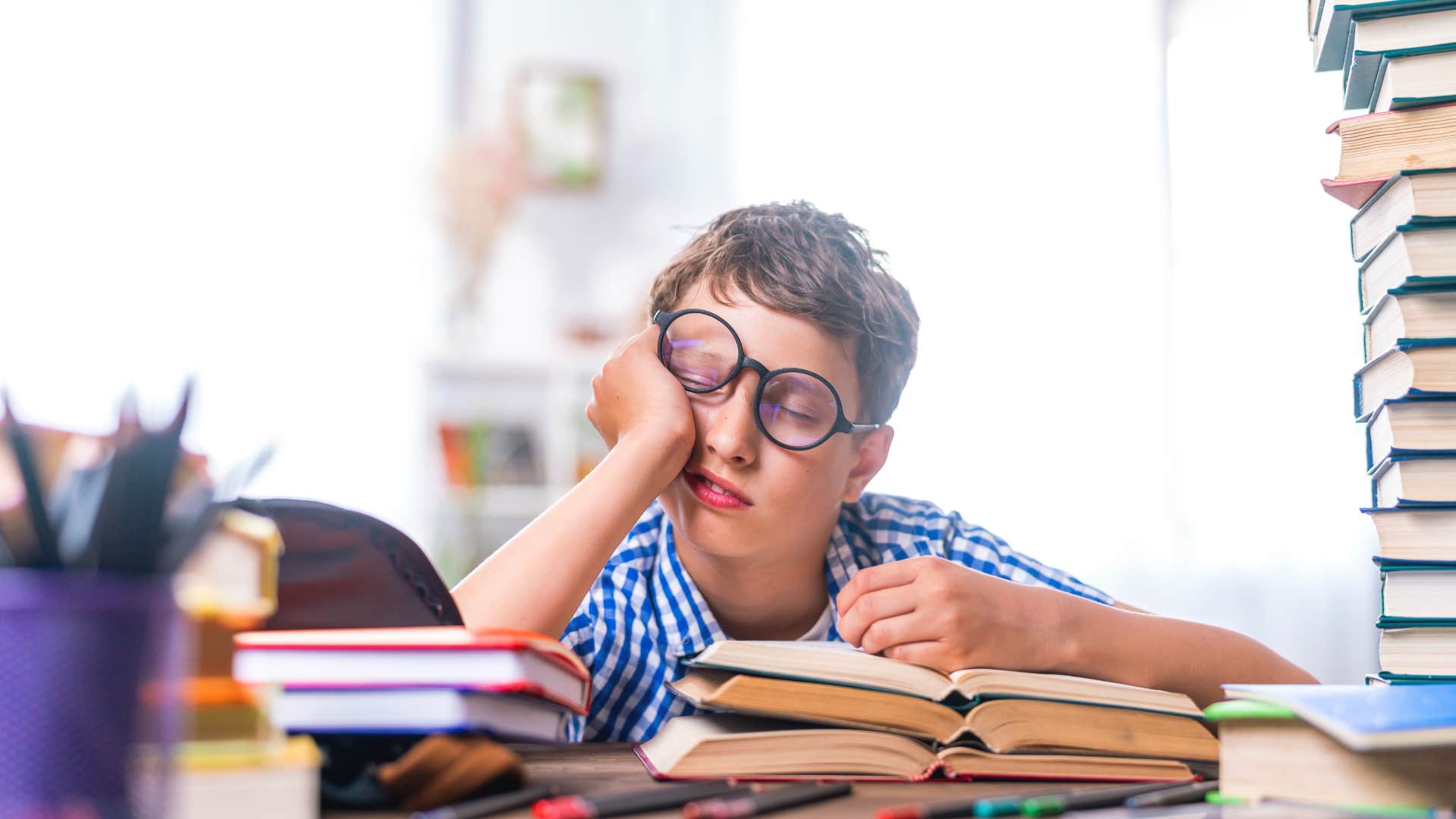 child falling asleep while doing homework