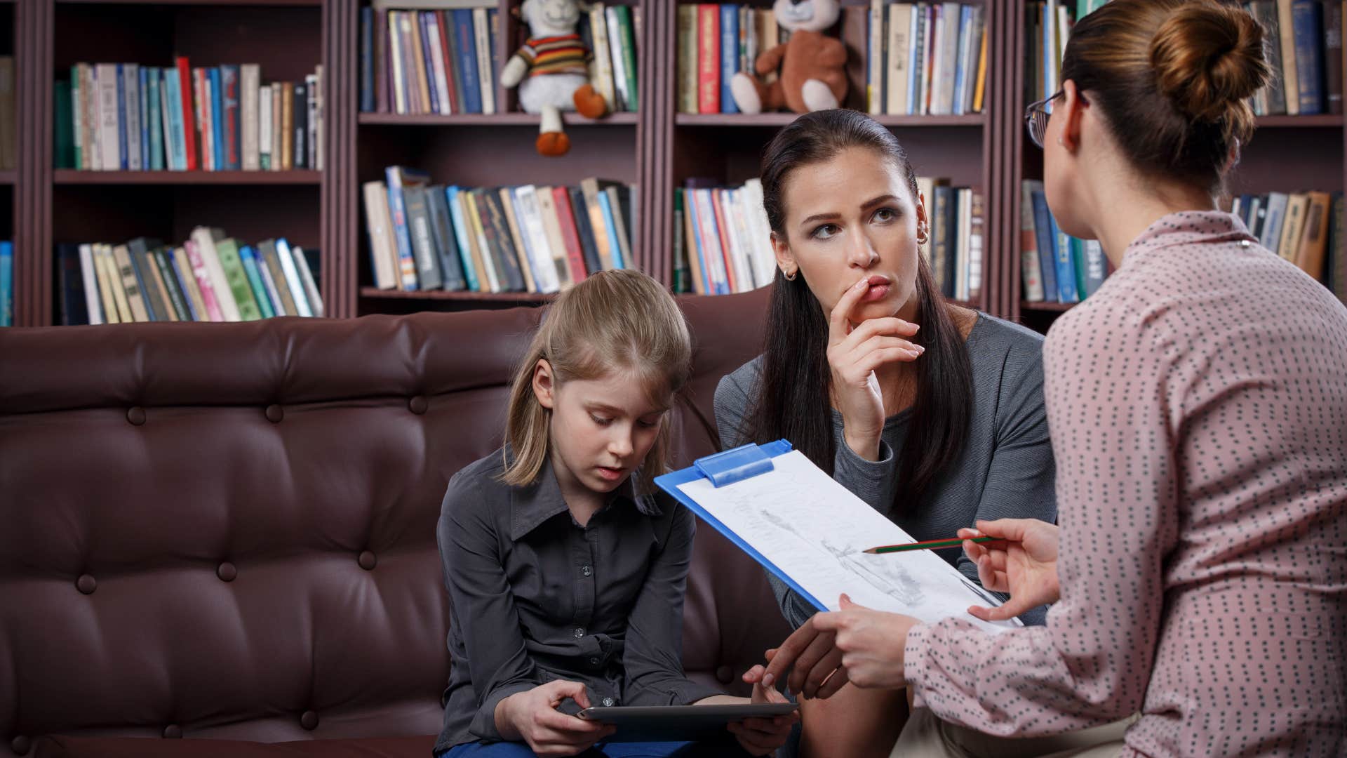mother confronting teacher with child next to her