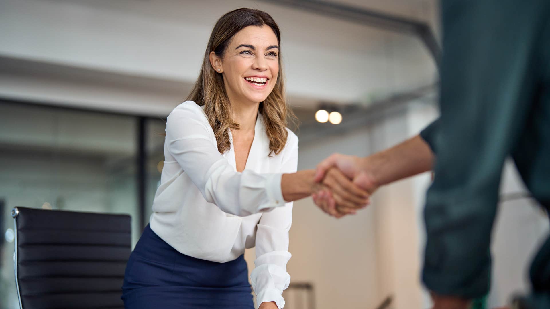 professional woman enjoying her job shaking hands
