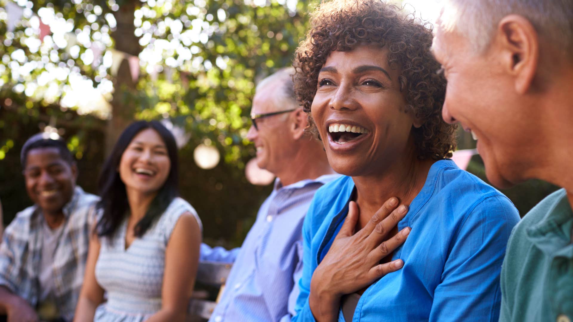 Woman sitting with her husband and making an effort with his friends and family.