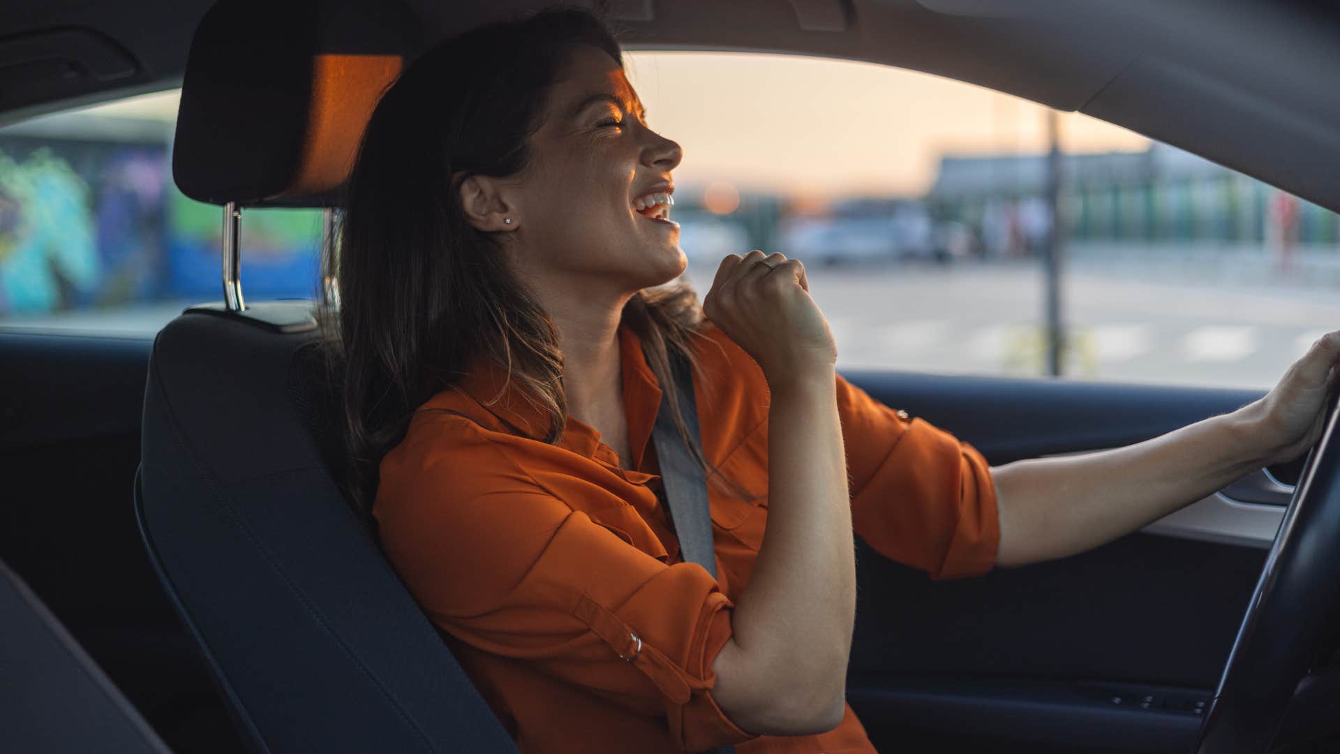 childfree woman impulsively singing in her car