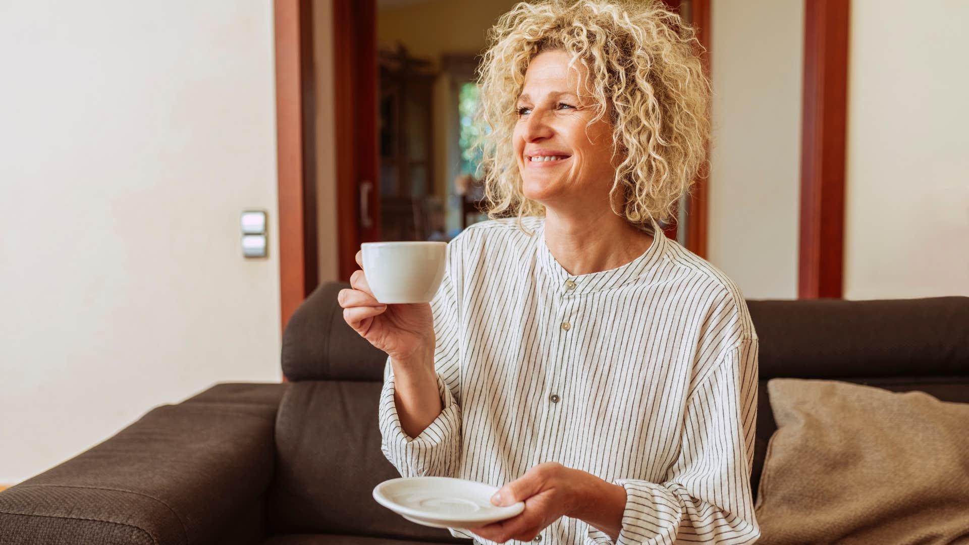 older woman drinking tea in her quiet home