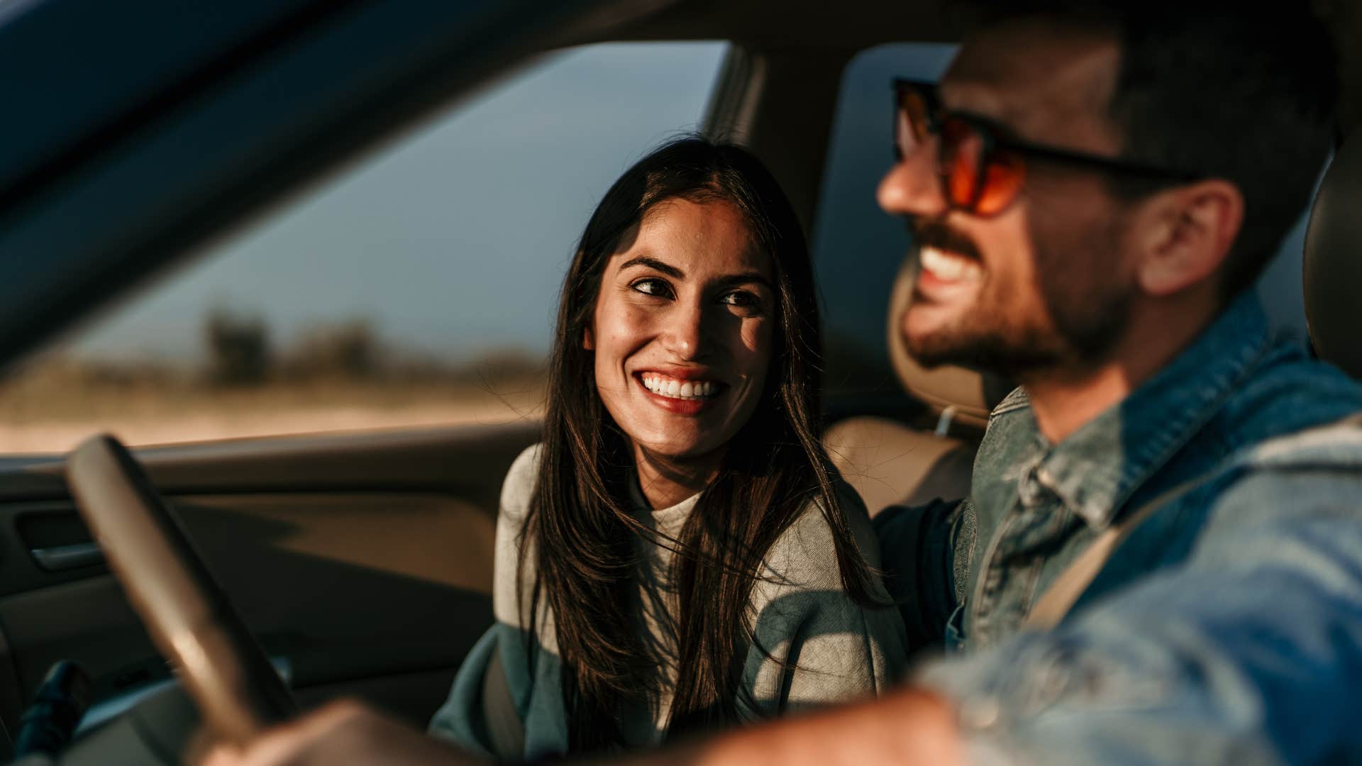 couple smiling traveling spontaneously without kids