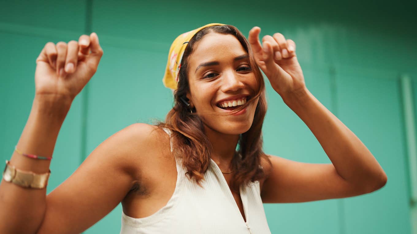 confident woman dancing and smiling