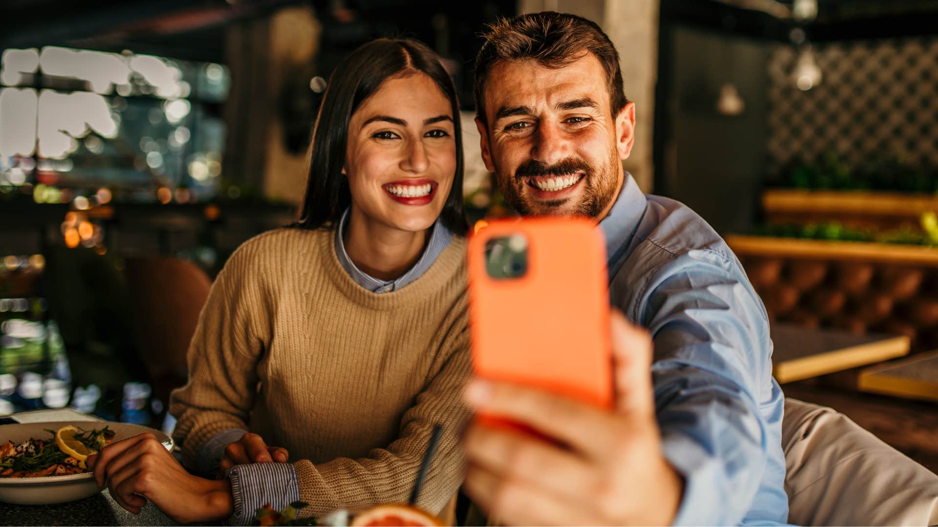 extroverted woman smiling for a photo during after-work plans