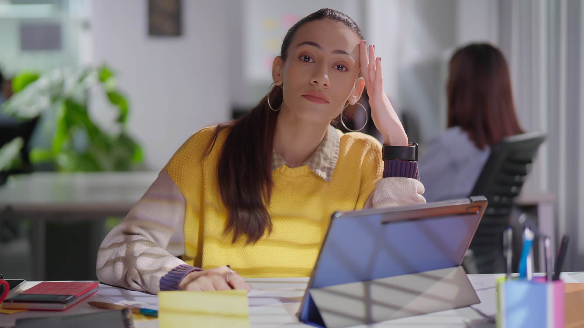 Gen Z woman confusing passivity for work-life balance in an office