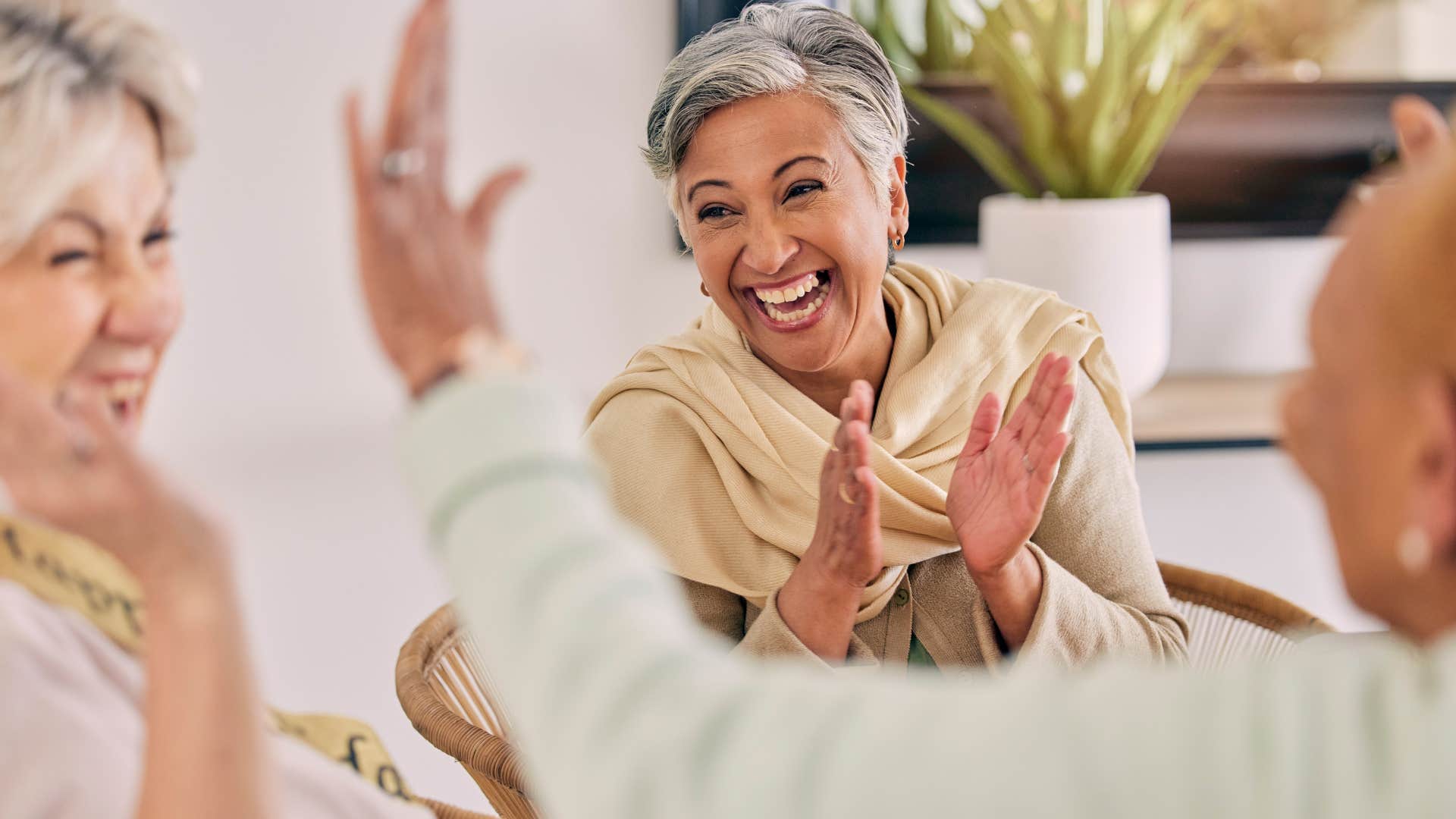 woman celebrating other people's wins with friends