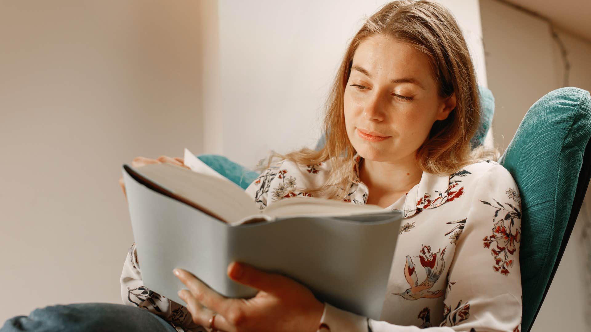 Woman reading educational materials at home.