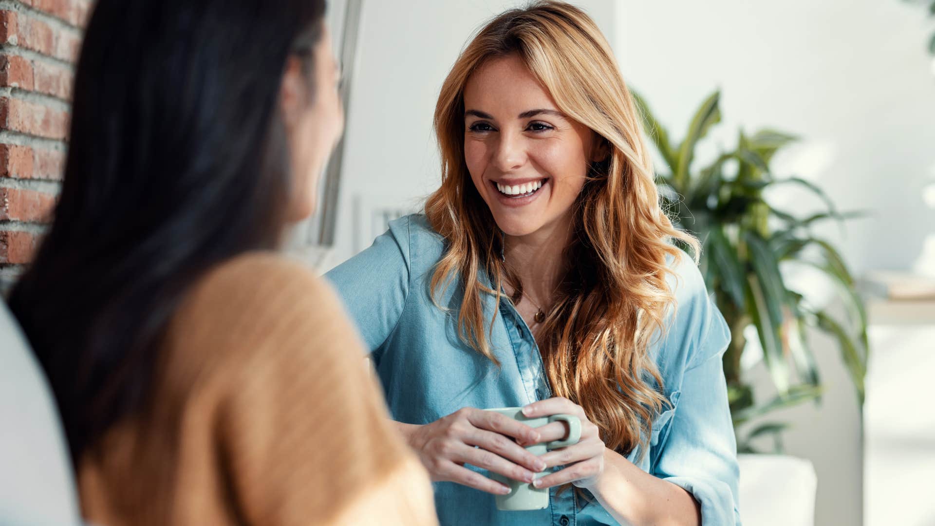 Woman smiling in her space for socialization with a friend.