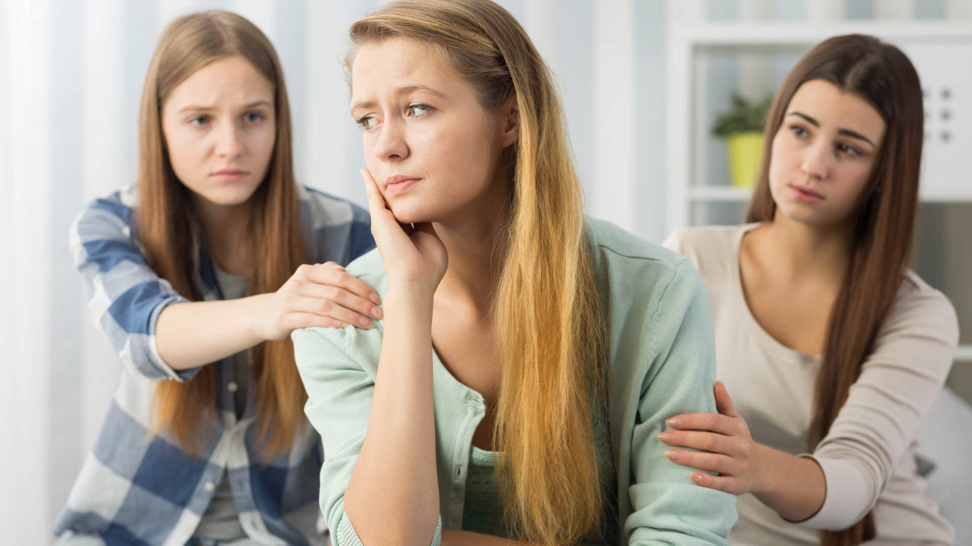 attention-seeking woman sitting in front of concerned friends