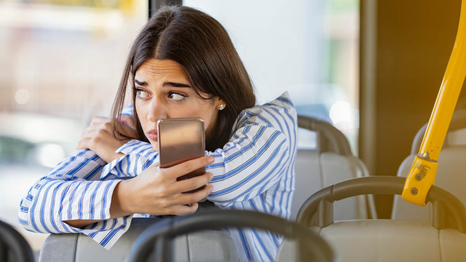 woman avoiding interactions with her phone on public transit