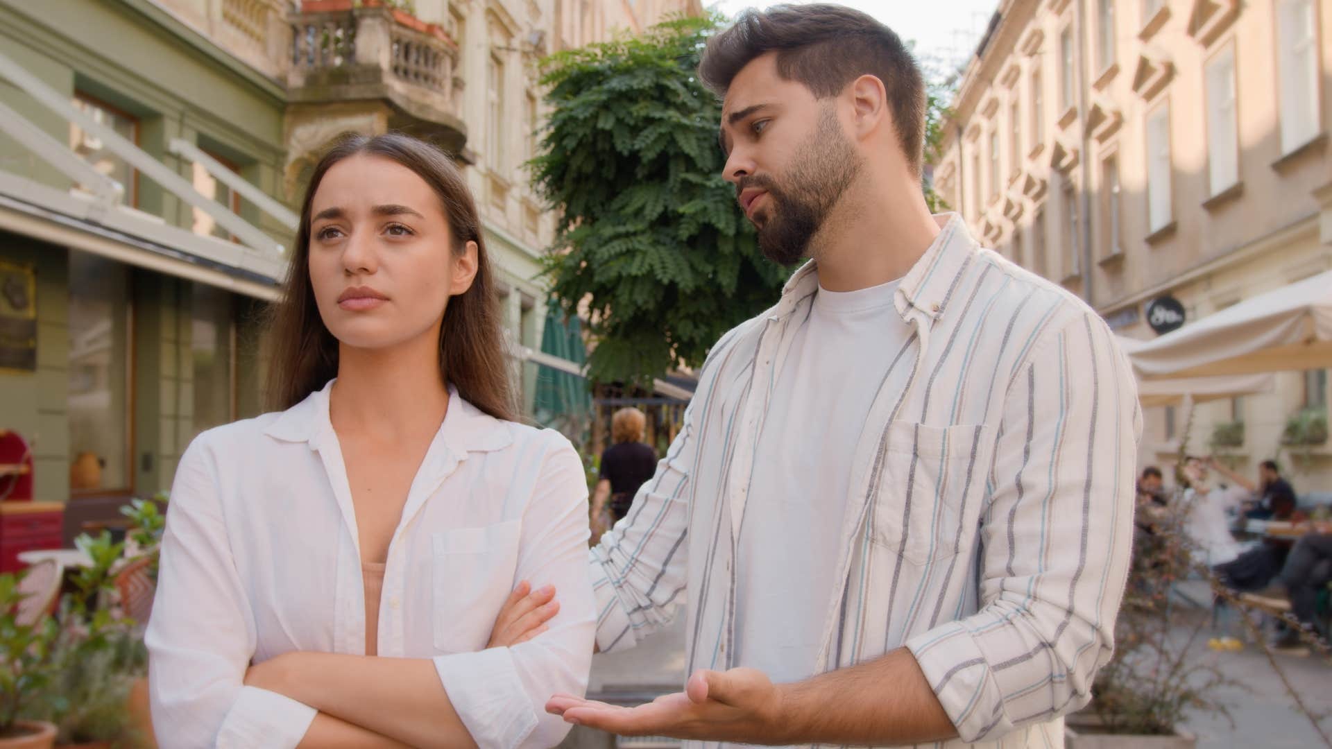 man over-apologizing to his partner in public