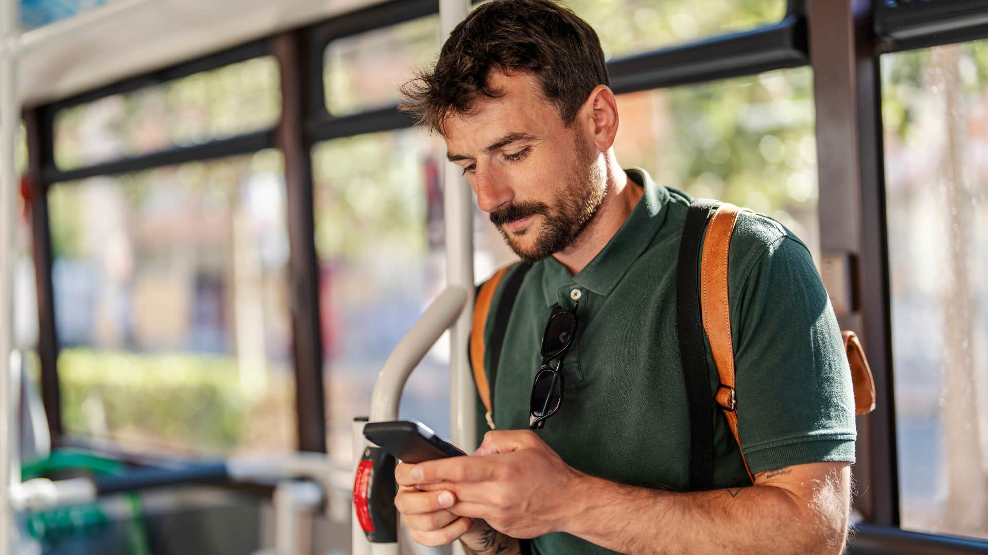 unhappy man posting everything online from the bus