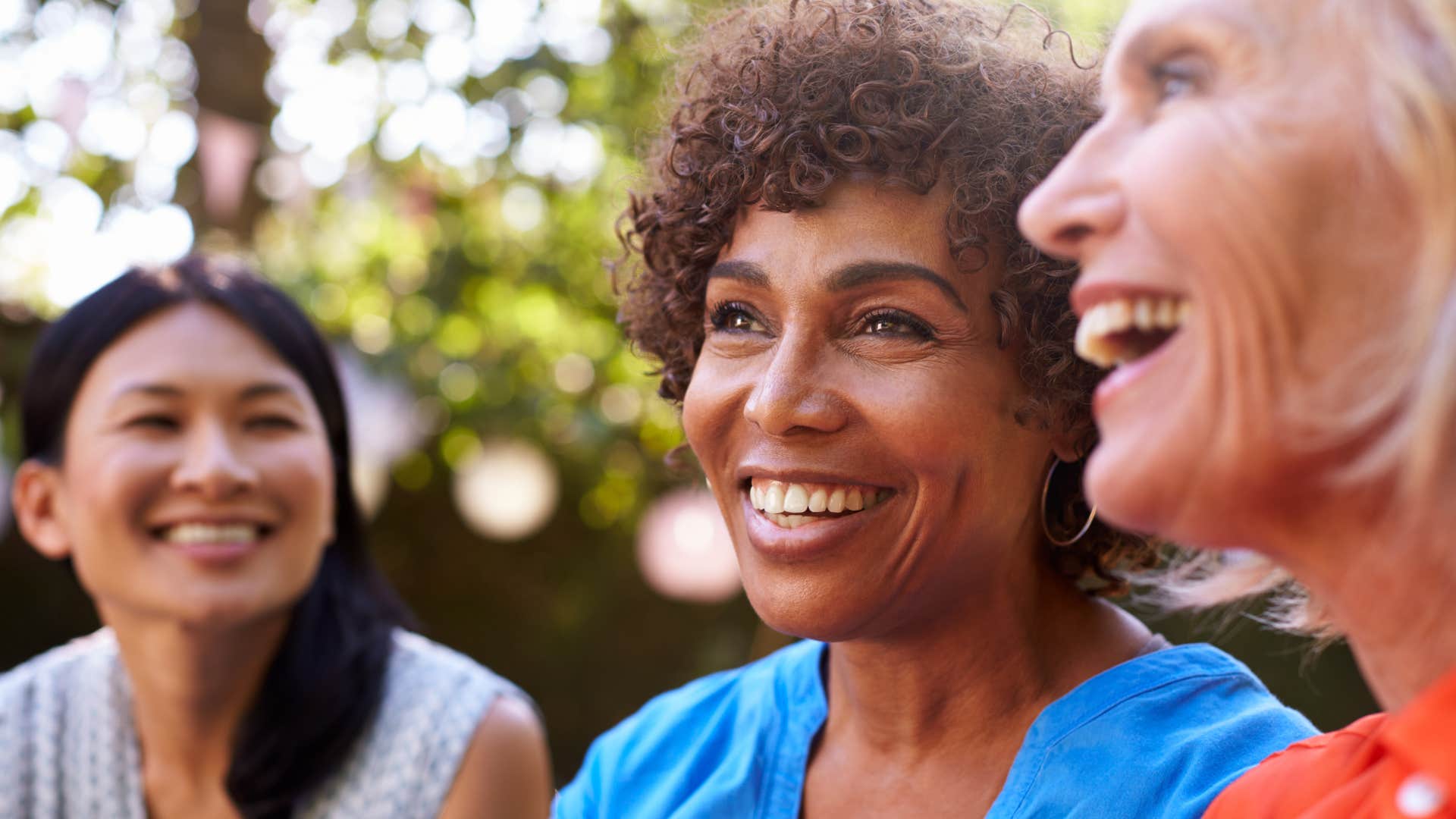 women laughing together not holding on to old friendships