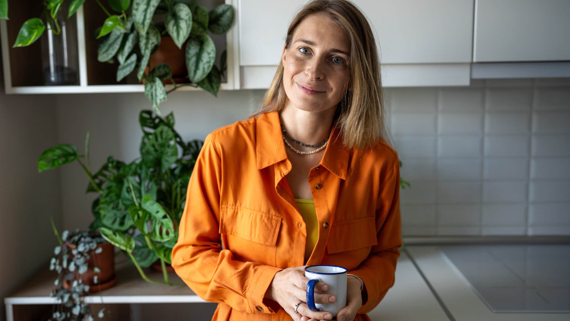 woman who doesn't care about other people's opinions smiling at home