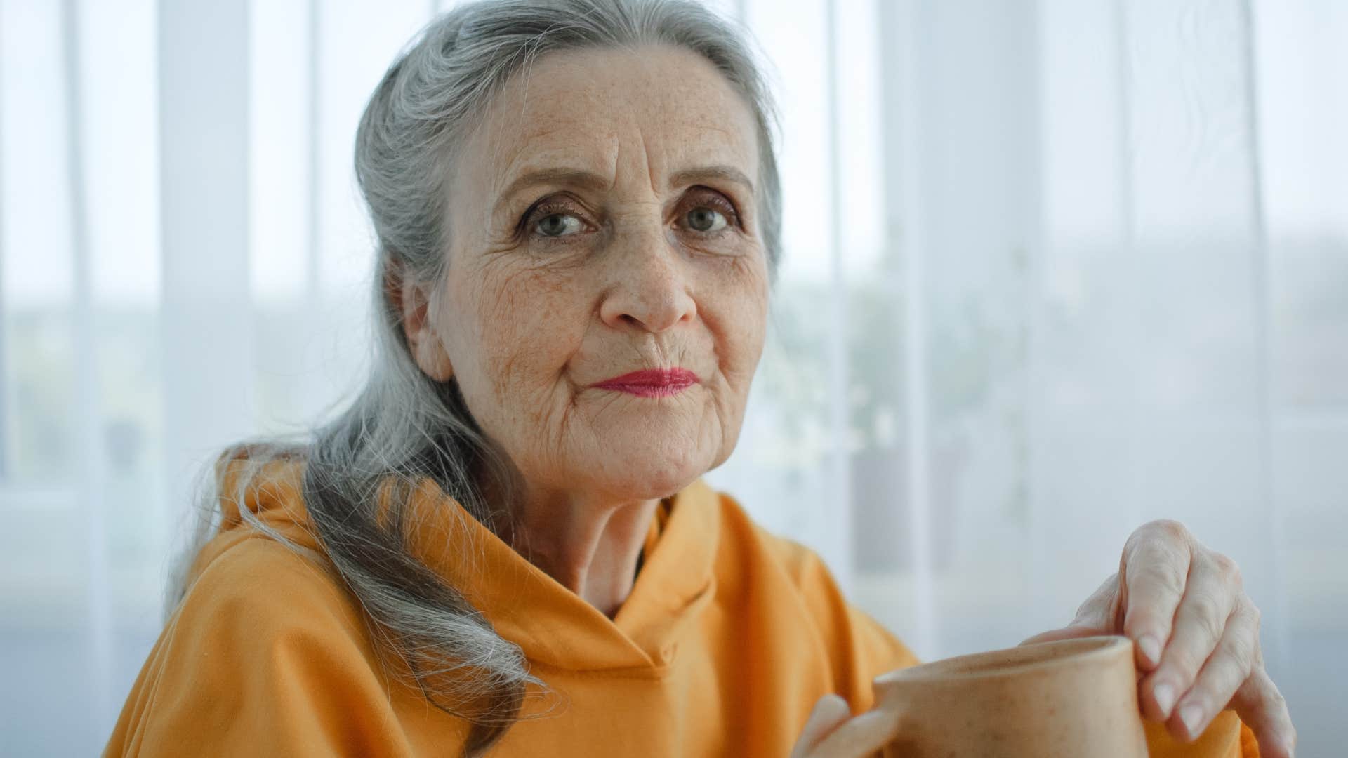 older woman who doesn't care about societal expectations drinking coffee