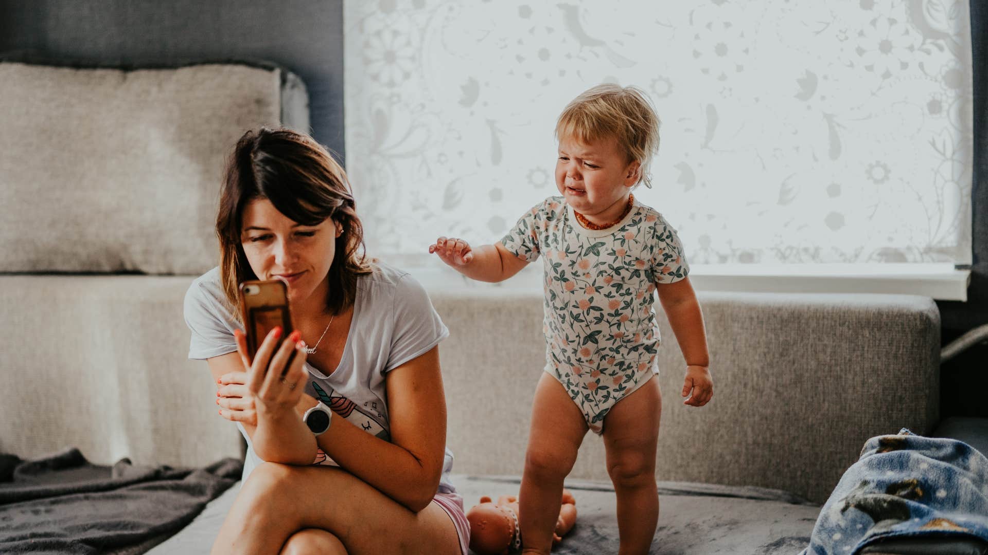 mom ignoring child's meltdown to be on her phone