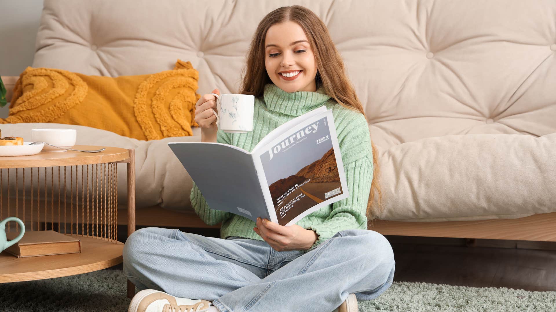 woman reading magazine doing celebrity worship while sipping tea