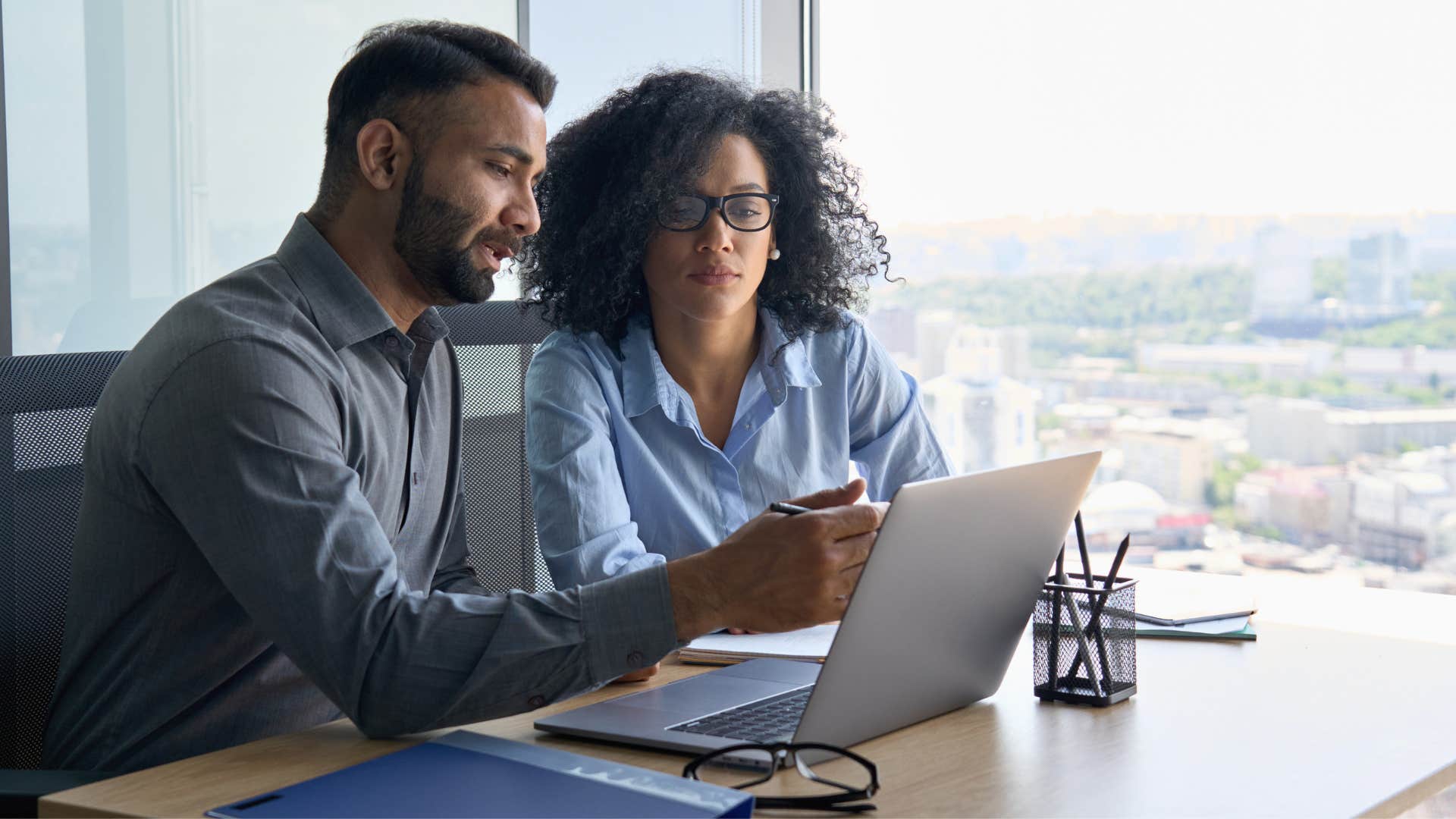 coworker speaking in corporate jargon while pointing at laptop