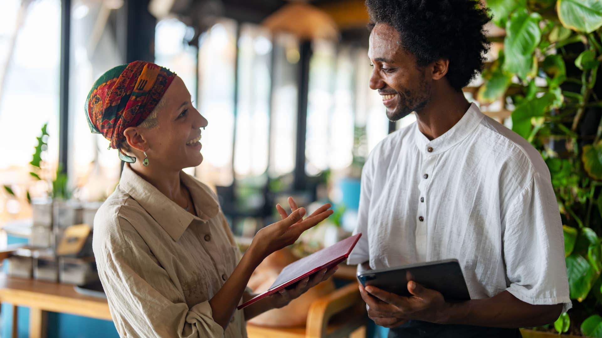 woman speaking kindly with server at restaurant