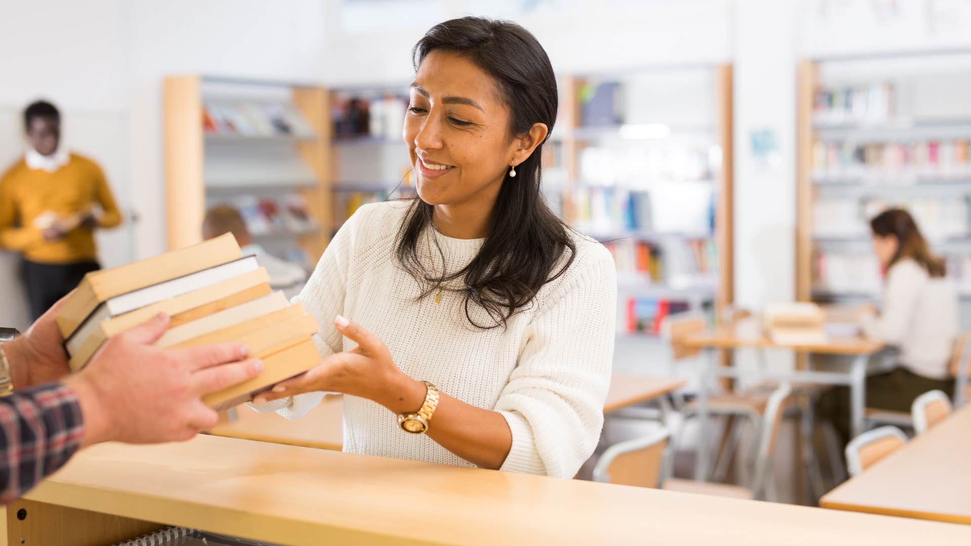 woman borrowing books from library