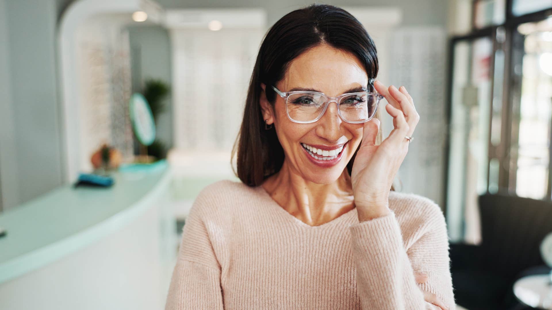 confident woman fixing her glasses