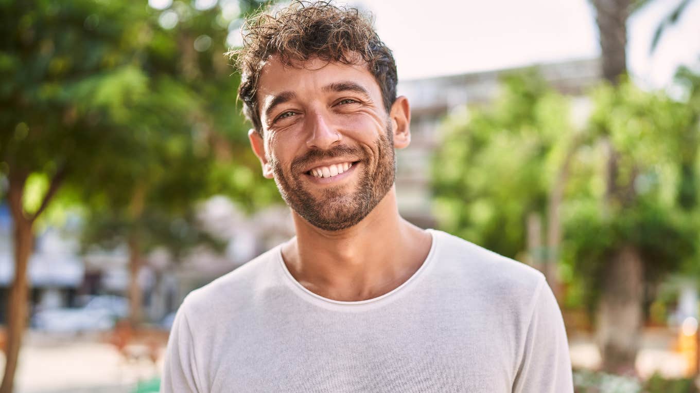 Things That Happen During A Twin Flame's Divine Masculine Awakening happy man smiling after experiencing a spiritual journey