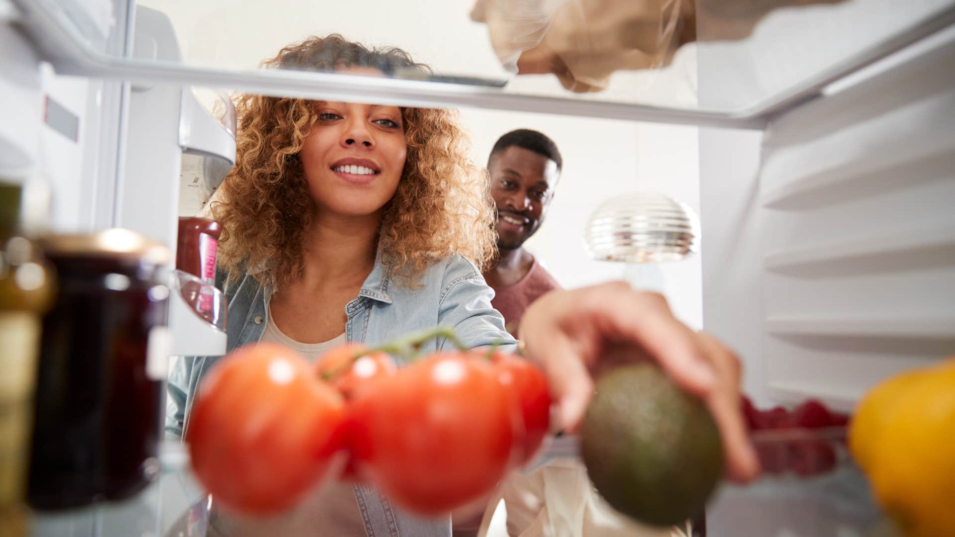 woman looking in fridge for food