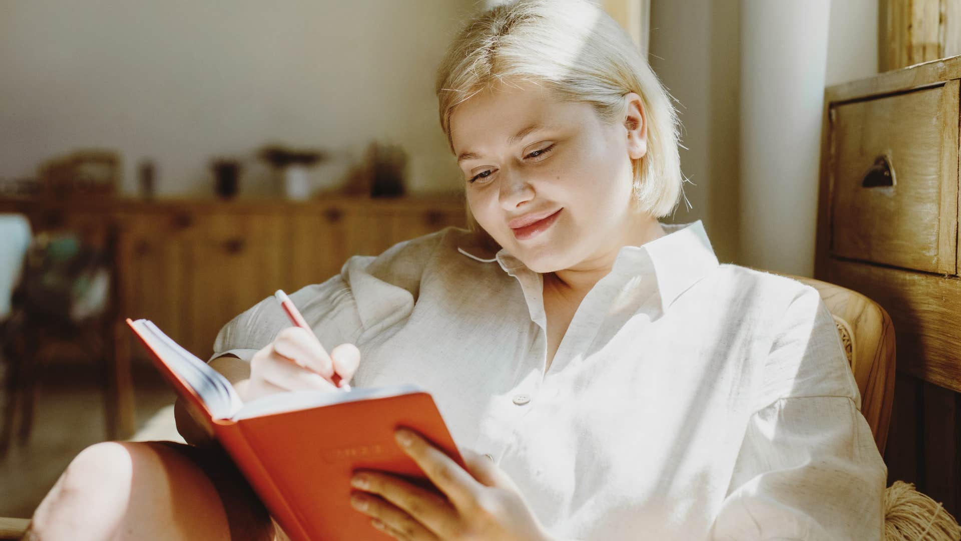 introverted woman working on herself writing in notebook