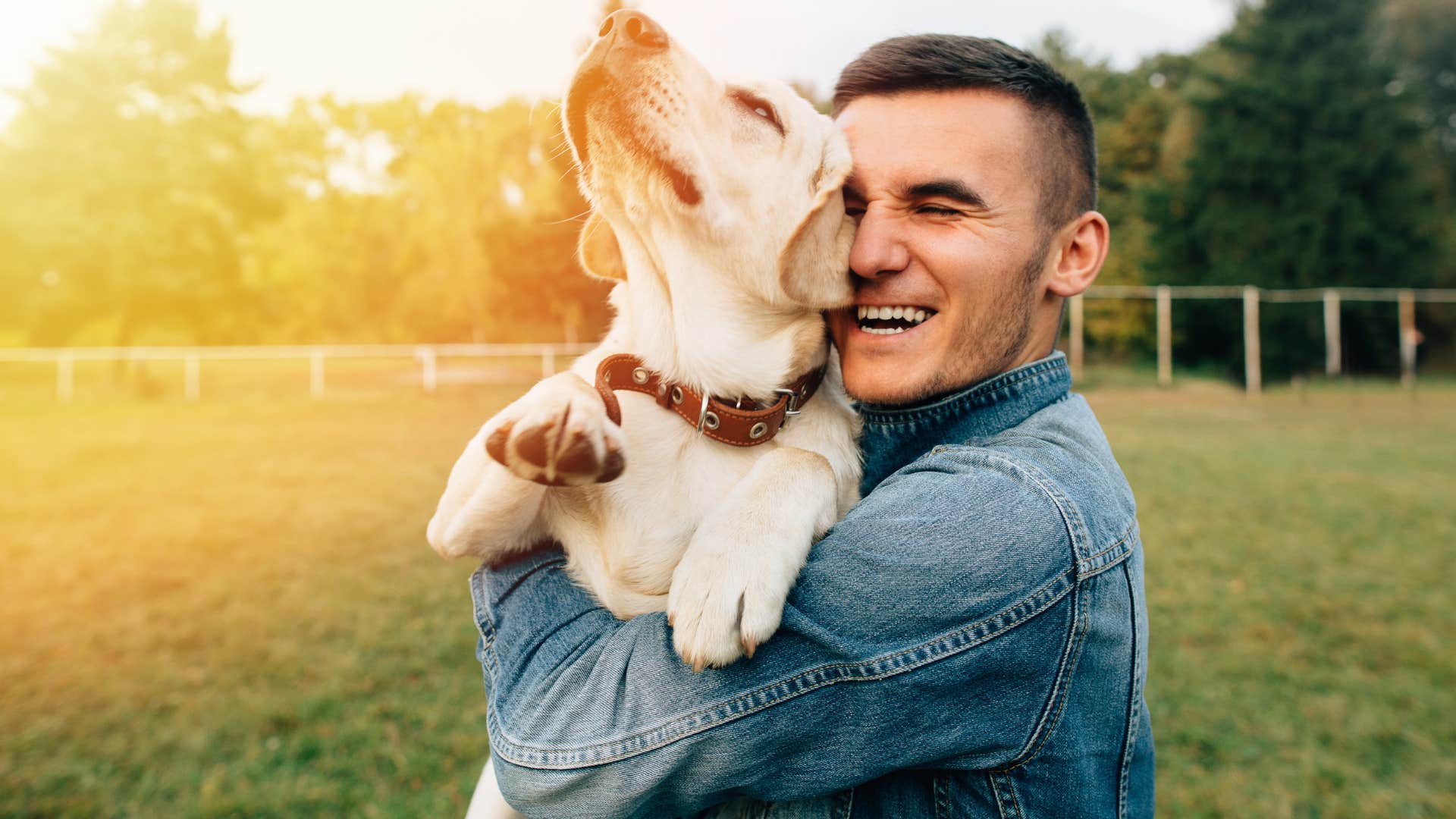 man smiling taking his dog for a walk
