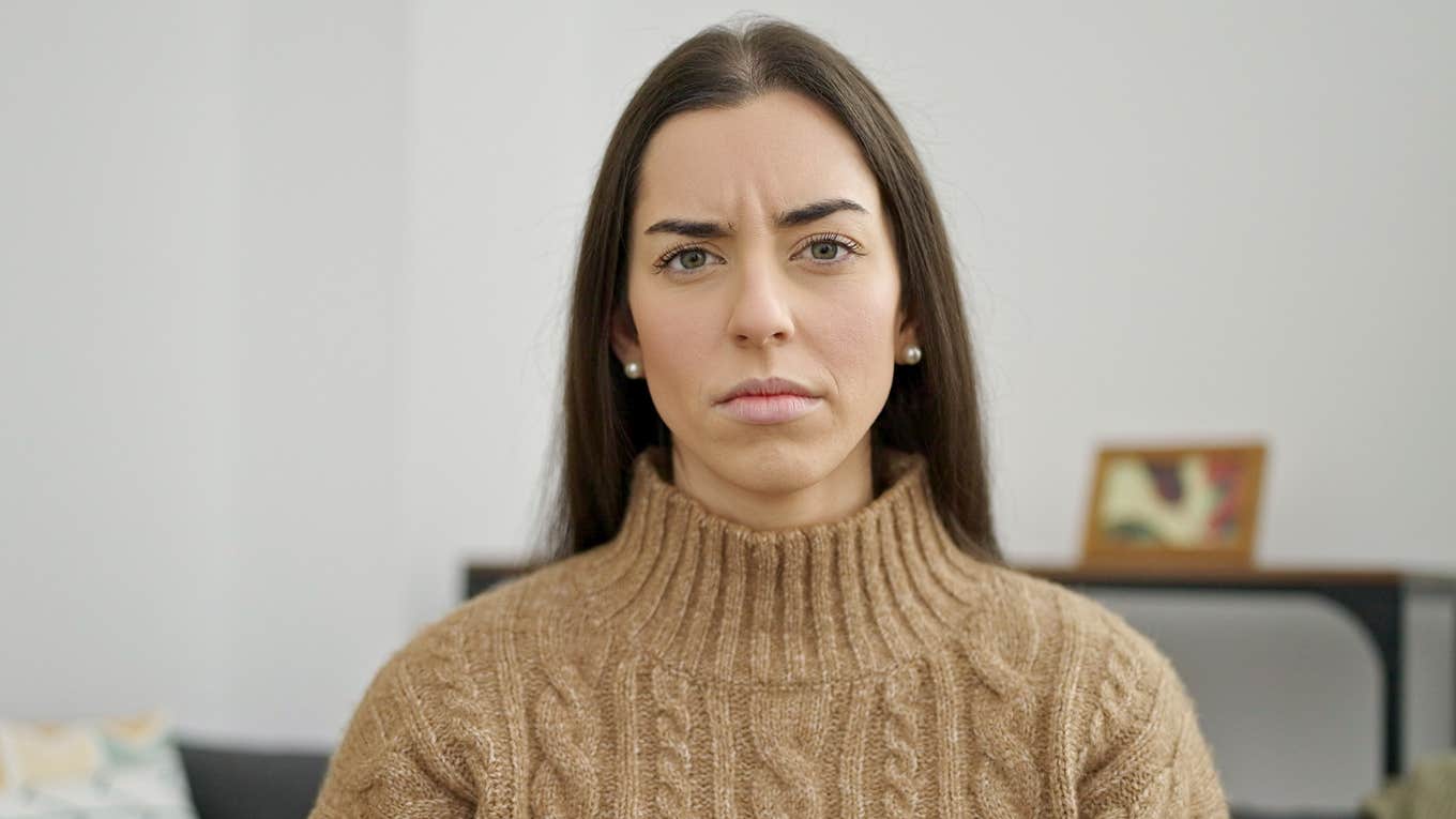 True Introverts Avoid These Things At All Costs, According To Psychology introverted woman looking stressed at home