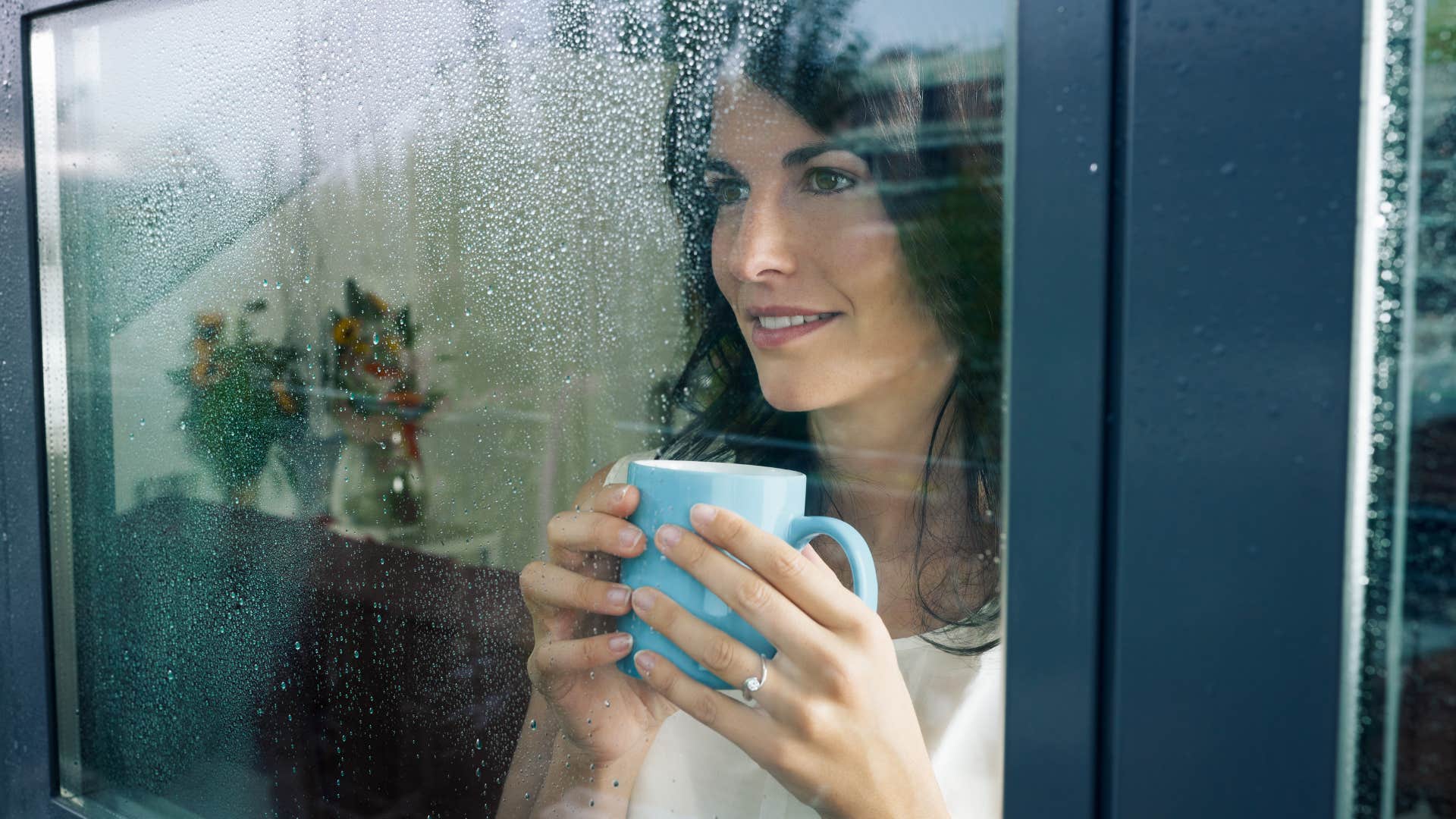 woman who hates warm climates smiling on a rainy day