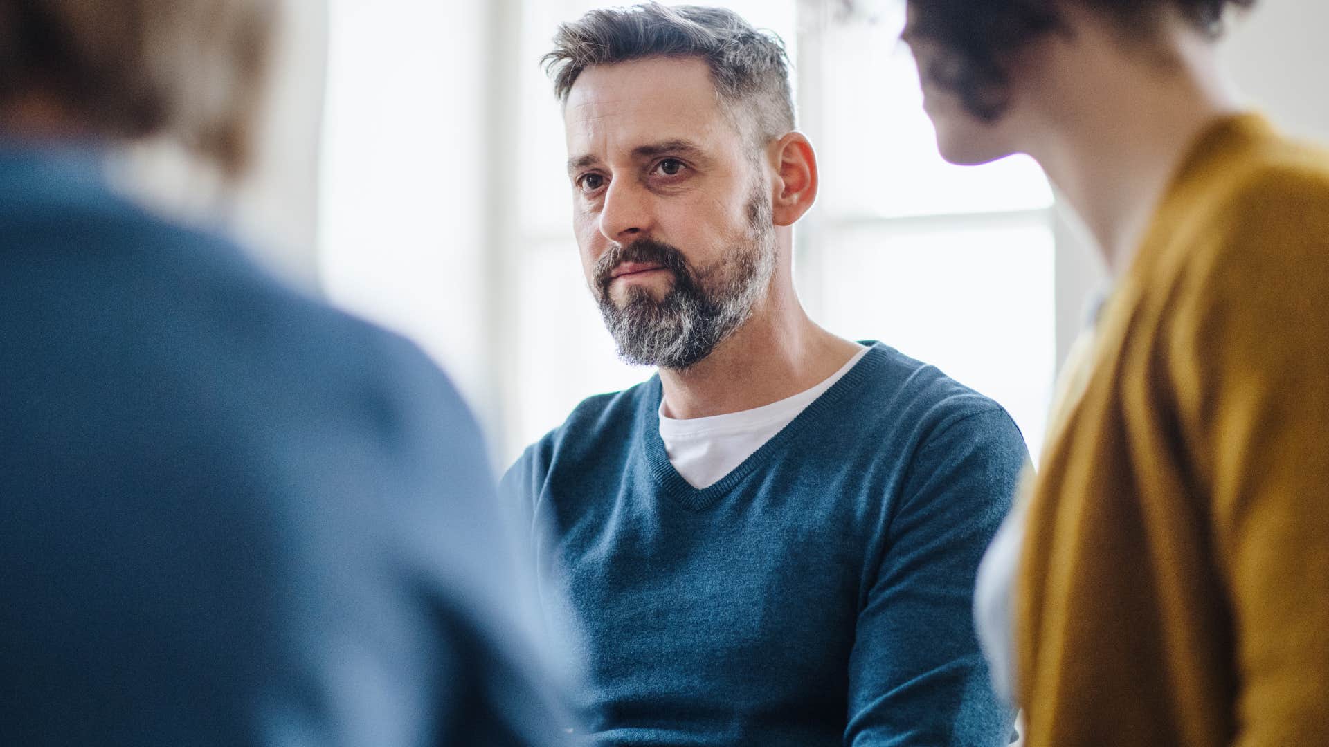 man looking upset during group debate