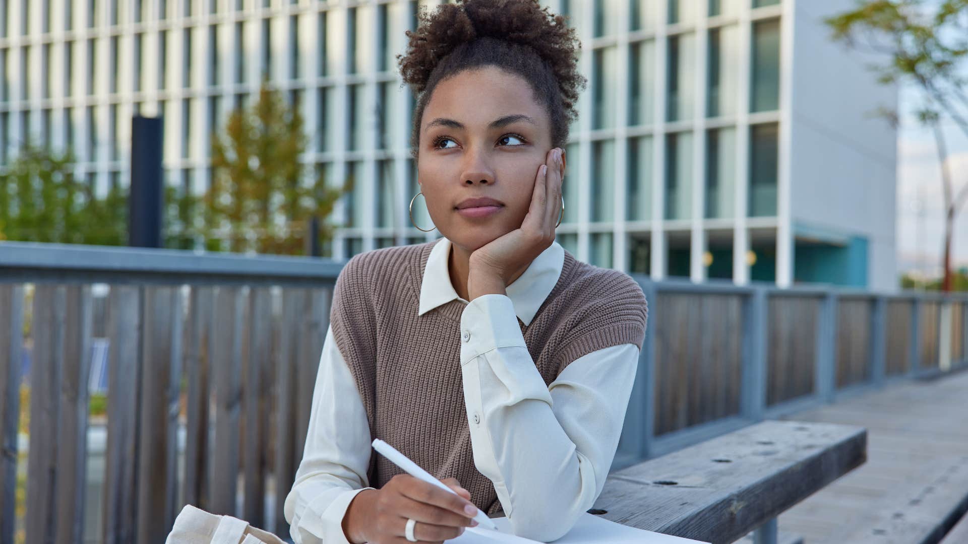 introverted woman sitting outside writing noticing the little things