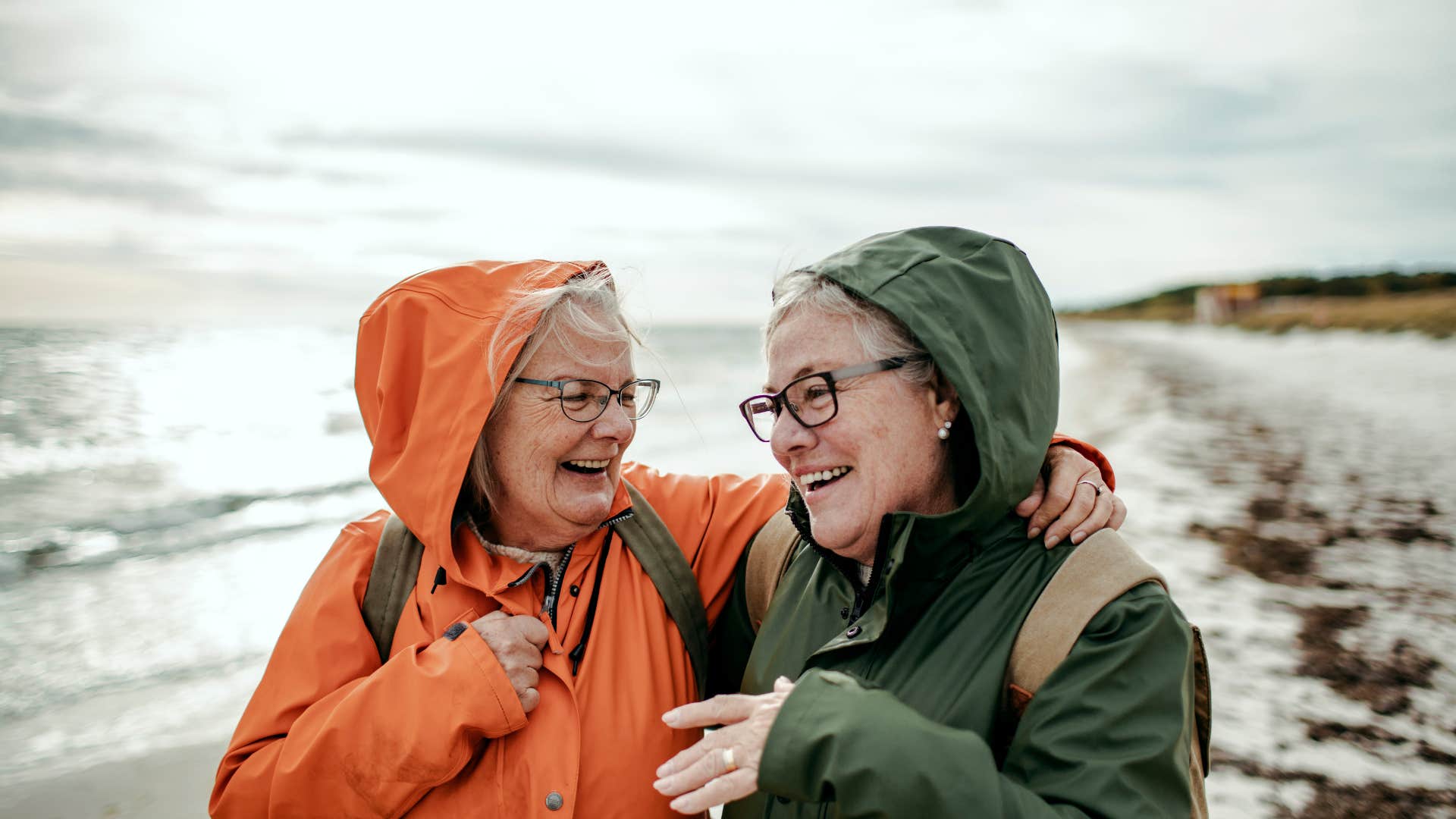 two older woman walking on winter beach