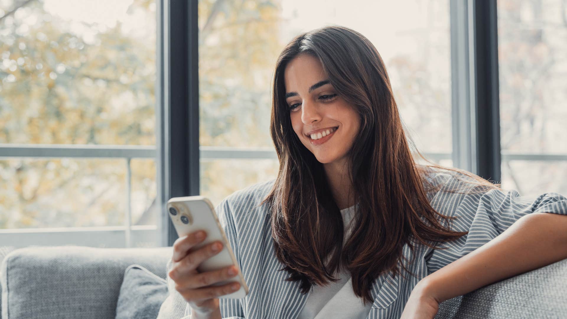 woman smiling at phone