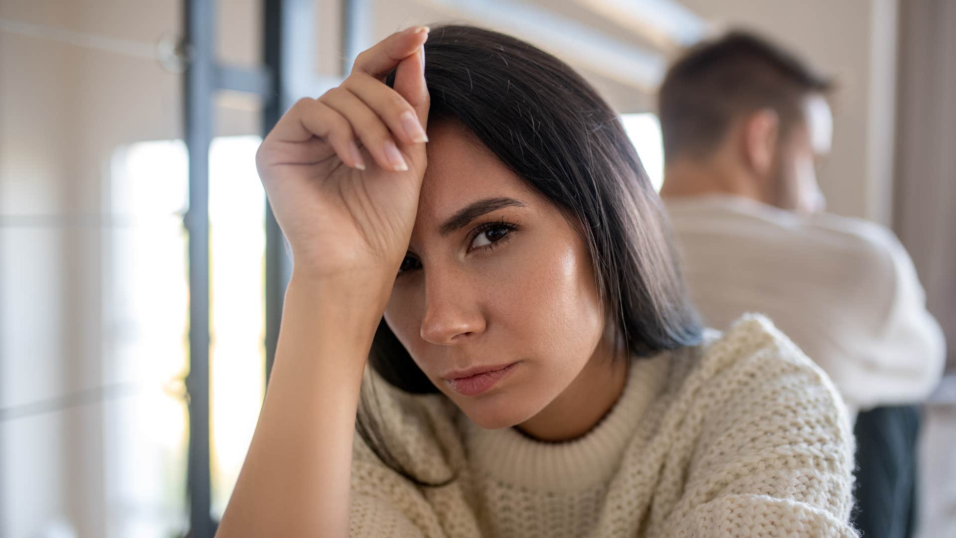 upset woman feeling physically sick around her partner