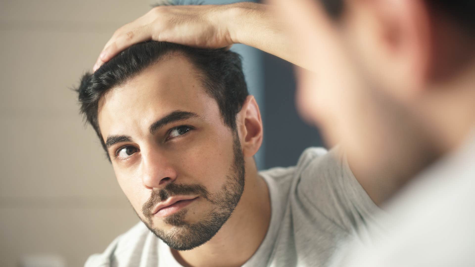 man with a big ego looking in the mirror concerned with how he looks