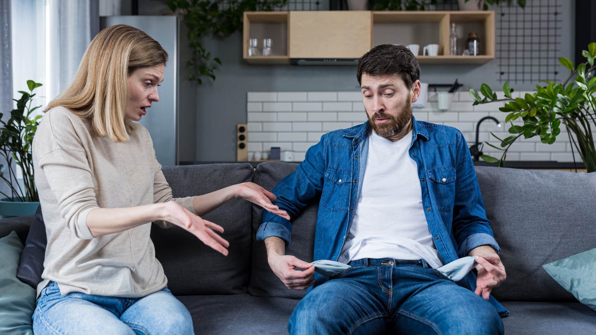 low-value man emptying pockets being stingy to his partner