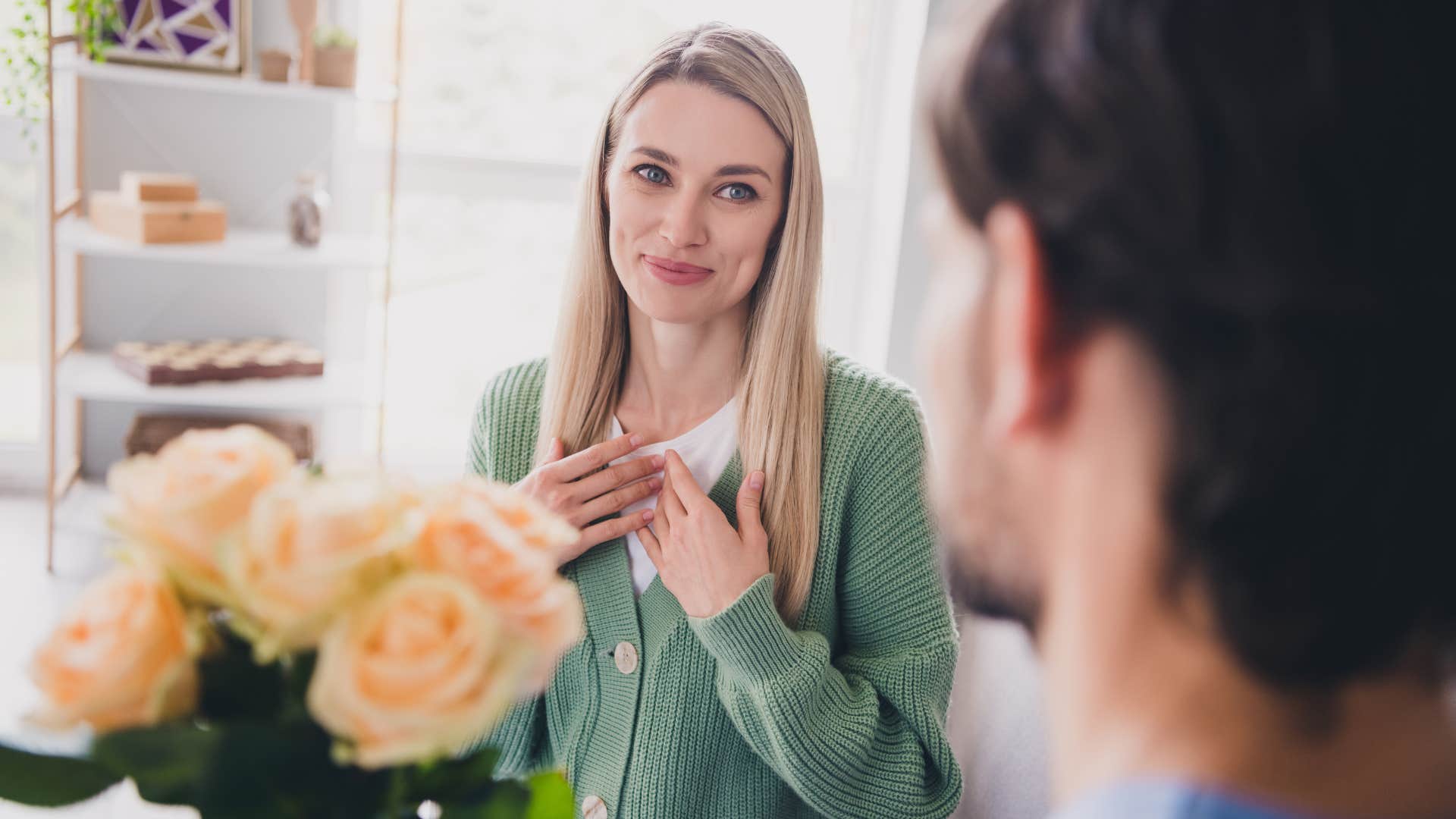 man celebrating wife's success giving her flowers