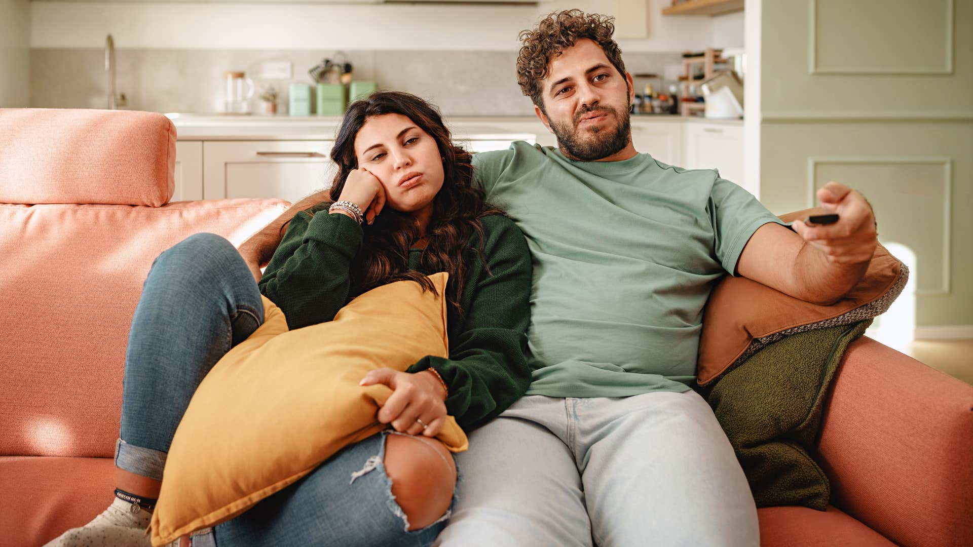 bored couple sitting with each other not excited 