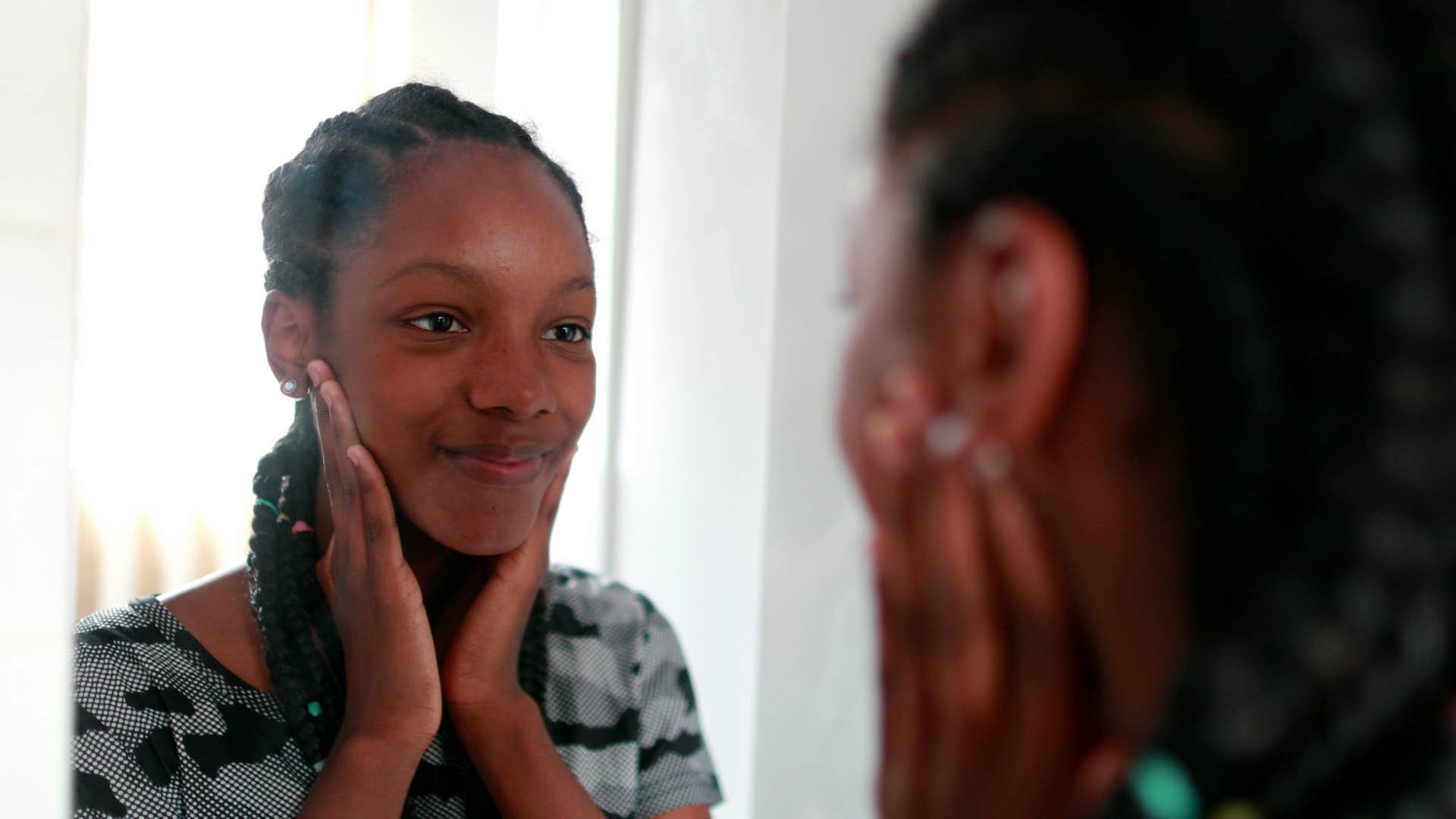 woman wanting to find her voice by looking in mirror