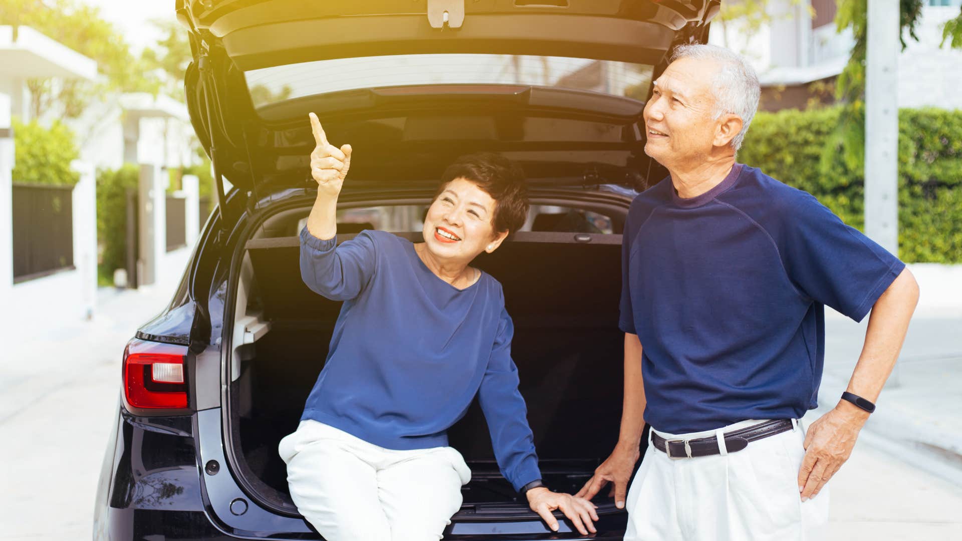 boomer parents checking and fixing their kid's car