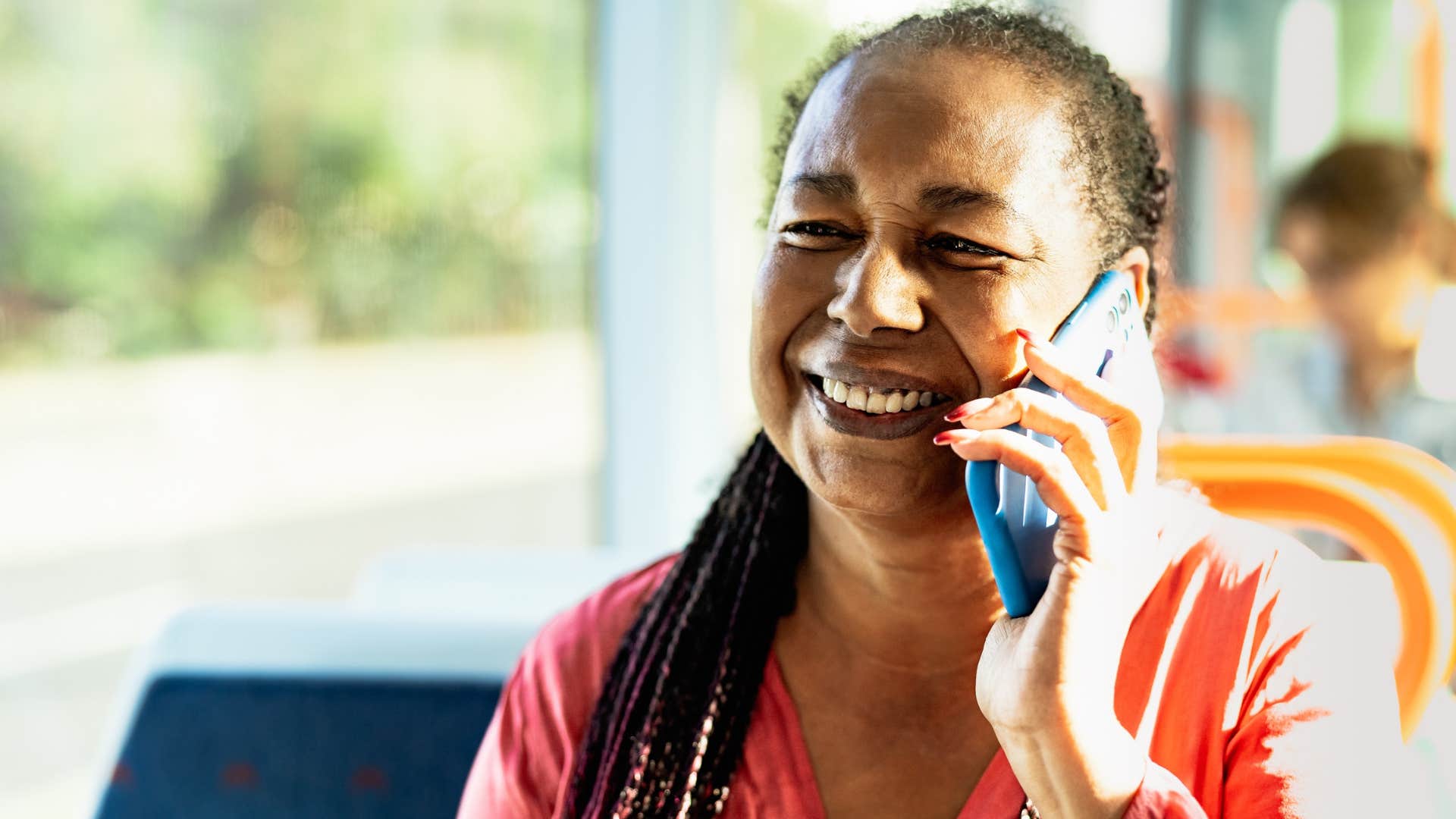 boomer woman calling adult children on the phone