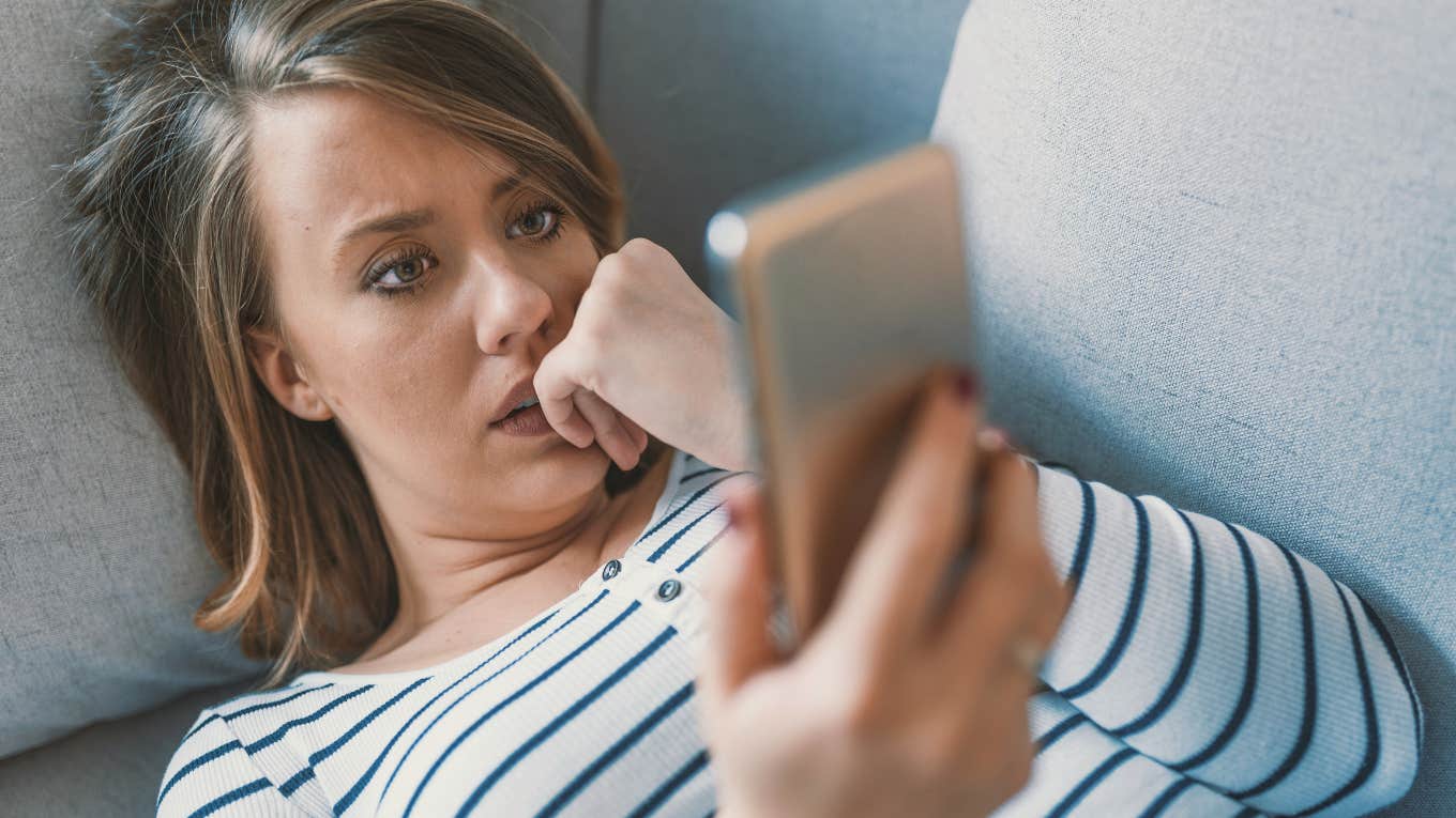 Ways Empathetic People Can Avoid Getting Upset While Scrolling Social Media Right Now empathetic woman scrolling social media looking sad