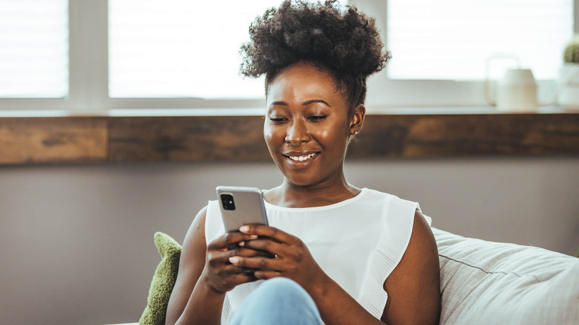woman creating a light list on her phone