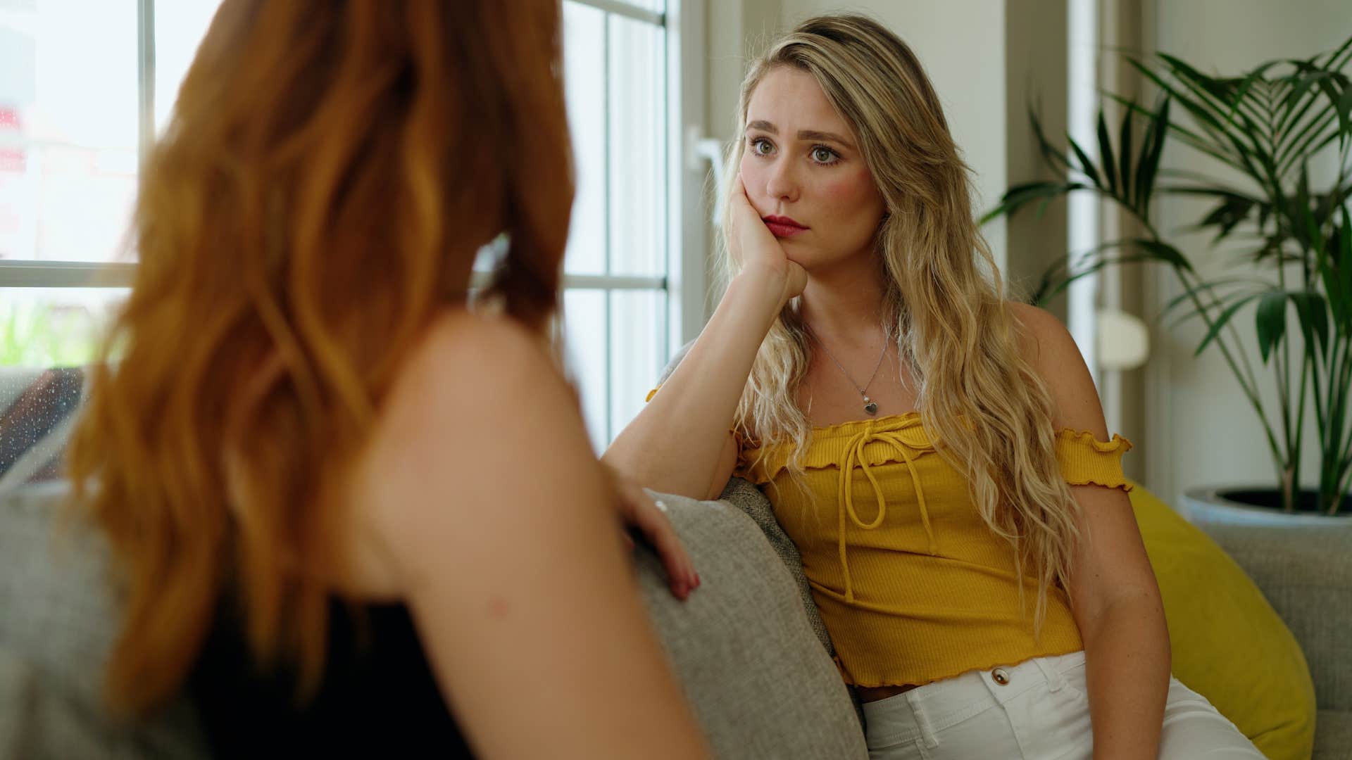 empathetic woman expressing concern in private with a friend